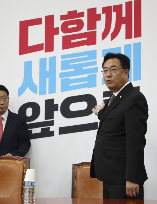 정진석(오른쪽) 국민의힘 비상대책위원장이 14일 서울 여의도 국회 본관에서 열린 당 비대위원회의에서 비대위 출범 계기로 마련한 '다함께 새롭게 앞으로' 새 백드롭 글씨에 관한 설명을 하고 있다.<국회사진기자단·연합뉴스>